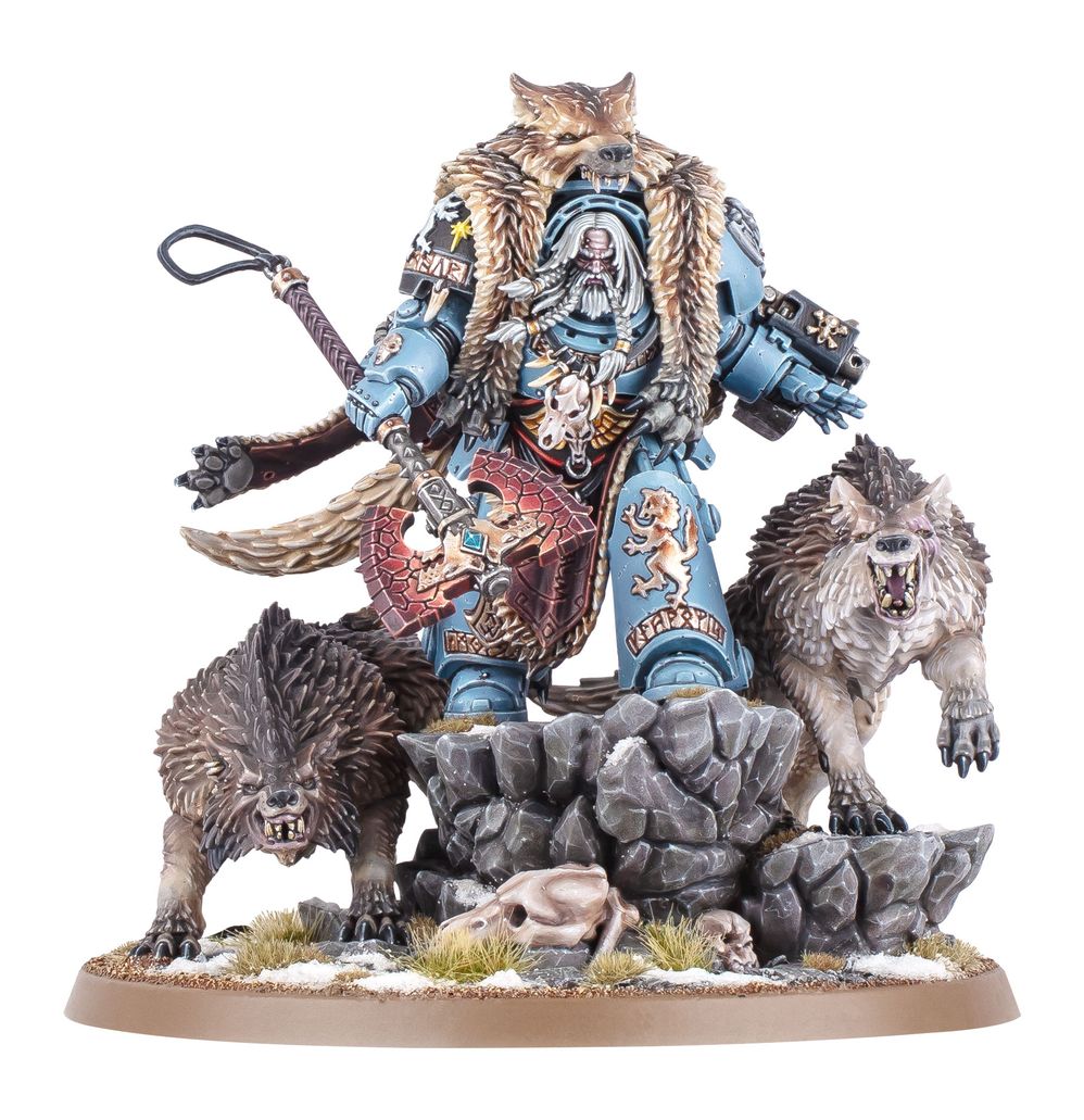 Warhammer figurine with a warrior and two wolves on a rocky base
